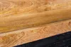 A close-up view of a wooden shelf with a black background. Produktbild-Vorschau