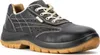 A black safety shoe with a tan sole is shown against a white background. Produktbild-Vorschau