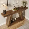 A wooden console table with decorative items placed on it and around it, set against a wall. Produktbild-Vorschau