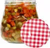 A glass jar filled with pickled vegetables and a red and white checkered lid. Produktbild-Vorschau
