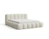 A beige upholstered bed frame with a mattress on a white background. Voir les images du produit