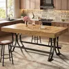 A modern kitchen with a wooden bar table and stools. Voir les images du produit