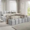 A modern bedroom with a large upholstered bed. Produktbild-Vorschau