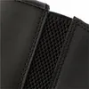 A close-up view of the elasticated side panel and stitching on a black leather boot. Náhľad obrázku produktu