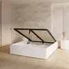 A white bed frame with the mattress support raised, revealing storage space underneath. The bed is in a room with light wood flooring and a marble-patterned wall. Produktbild-Vorschau