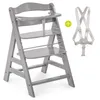 A grey high chair and a white safety harness are displayed against a white background. Produktbild-Vorschau