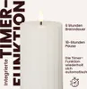A close-up of a white LED candle with a flame, featuring text describing its timer function and burn duration. Podgląd zdjęcia produktu