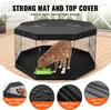 A dog inside a black octagonal pet playpen with a top cover and mat. Produktbild-Vorschau