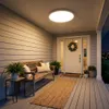 A well-lit porch with a bench, plants, and a wreath on the door, showcasing the ceiling light. Anteprima dell’immagine prodotto