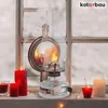 A vintage petroleum lamp and several candles are placed on a windowsill with a snowy view outside. Podgląd zdjęcia produktu