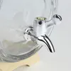 A close-up shot of a chrome spigot attached to a glass beverage dispenser. Produktbild-Vorschau