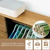 A wardrobe or closet interior with clothes hanging on hangers, a storage box on top, and a close-up of bamboo tubes. Náhled obrázku produktu