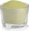 A clear, well-lit studio shot of a glass container filled with green powder, with a white scoop resting in front of it. Produktbild-Vorschau