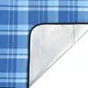 A close-up view of a corner of a blanket or picnic mat, showing the plaid fabric and the silver backing. Produktbild-Vorschau