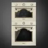 A stacked pair of cream-colored ovens with bronze accents against a dark gray background. Anteprima dell’immagine prodotto