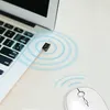 A close-up shot of a USB Bluetooth adapter plugged into a laptop, with a wireless mouse nearby and signal waves emanating from the adapter. Voir les images du produit