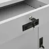 A close-up view of a gray metal filing cabinet with two locks and keys. Produktbild-Vorschau