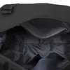 The interior of an open black duffel bag. Voir les images du produit
