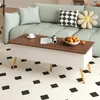 A coffee table with a lift-top is placed in a living room setting, in front of a sofa. Podgląd zdjęcia produktu