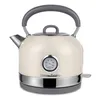 A cream-colored electric kettle with a vintage design, featuring a built-in thermometer and a gray handle, is presented against a white background. Voir les images du produit