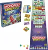 A flat lay of the Monopoly Knockout board game, including the box, game board, money, and game pieces. Voir les images du produit