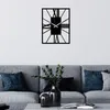 A modern living room with a gray sofa and a black wall clock. Podgląd zdjęcia produktu