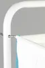 A close-up of a white laundry basket frame with a white fabric basket and a blue cloth hanging from it. Produktbild-Vorschau
