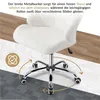 A white office chair with a metal base and wheels is shown on a floor with different textures, illustrating its stability and mobility. Produktbild-Vorschau