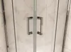 Close-up view of two handles on a glass shower door. Produktbild-Vorschau