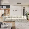 A modern living room with a large sectional sofa, a coffee table, and a bookshelf. Produktbild-Vorschau