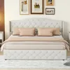 A tufted beige bed with pillows and a comforter is shown in a bedroom setting. Produktbild-Vorschau