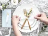 A table setting with plates, cutlery, and a ribbon. Podgląd zdjęcia produktu