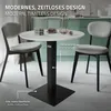 A round table with two chairs in a modern dining setting. Náhľad obrázku produktu