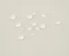 Water droplets on a light-colored textured surface. Náhľad obrázku produktu