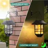 A split image showing a solar-powered lantern charging in daylight on the left and illuminating at night on the right, mounted on a brick wall. Produktbild-Vorschau