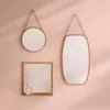 Three mirrors of different shapes and sizes are displayed on a pink wall, with soft shadows cast by light coming from the side. Podgląd zdjęcia produktu