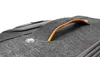 A close-up view of a gray suitcase handle and a small circular button. Náhled obrázku produktu