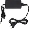 A black power adapter with two cables and plugs, laid out on a white background. Produktbild-Vorschau