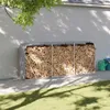 A firewood storage rack filled with logs is placed against a light gray wall in a backyard setting. Náhled obrázku produktu