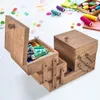 A wooden sewing box with various spools of thread and buttons scattered around it on a white surface. Anteprima dell’immagine prodotto