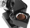 Water is being poured from a carafe into a coffee maker with coffee grounds in a filter. Voir les images du produit