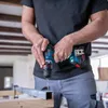 A person is using a cordless drill to drill into a metal beam. Náhled obrázku produktu
