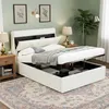 A bedroom scene featuring a white bed with storage, a nightstand, a lamp, and a plant. Produktbild-Vorschau