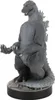 A statue of Godzilla standing on a base. Produktbild-Vorschau
