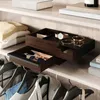 A closet shelf with clothing and accessories, featuring a wooden jewelry organizer. Voir les images du produit