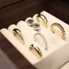 A close-up view of jewelry items, including rings and earrings, neatly arranged in a jewelry box. Voir les images du produit