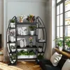 A multi-tiered plant stand filled with various plants and decorative items, placed near a large window in a living room. Podgląd zdjęcia produktu