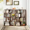 A wooden bookshelf filled with various decorative items and books, set against a white wall with artwork above. Náhled obrázku produktu