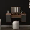 A modern vanity table with a mirror and two drawers, set against a black wall. A white pouf is placed in front of the table. Náhľad obrázku produktu
