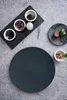 A top-down view of a slate plate with various ingredients and a decorative plate with food. Podgląd zdjęcia produktu